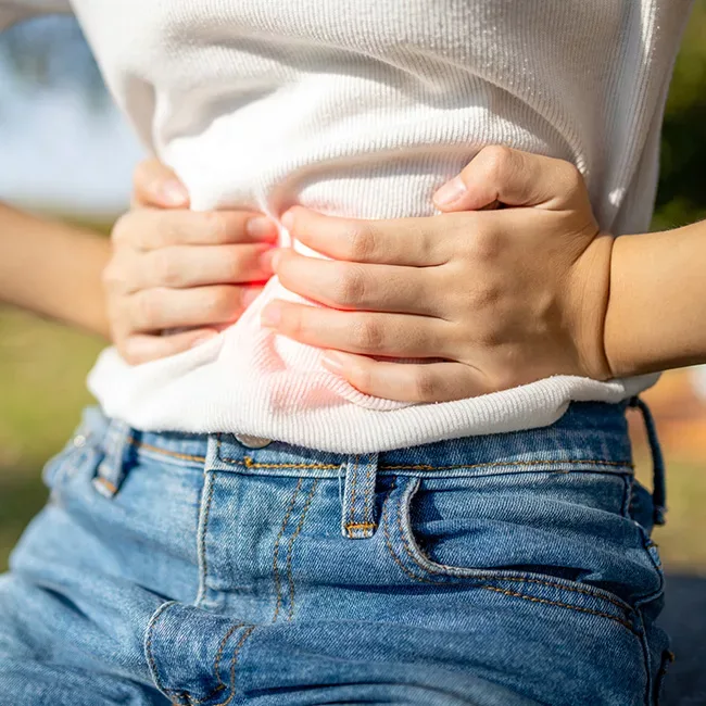 Girl clutching stomach, for IBS